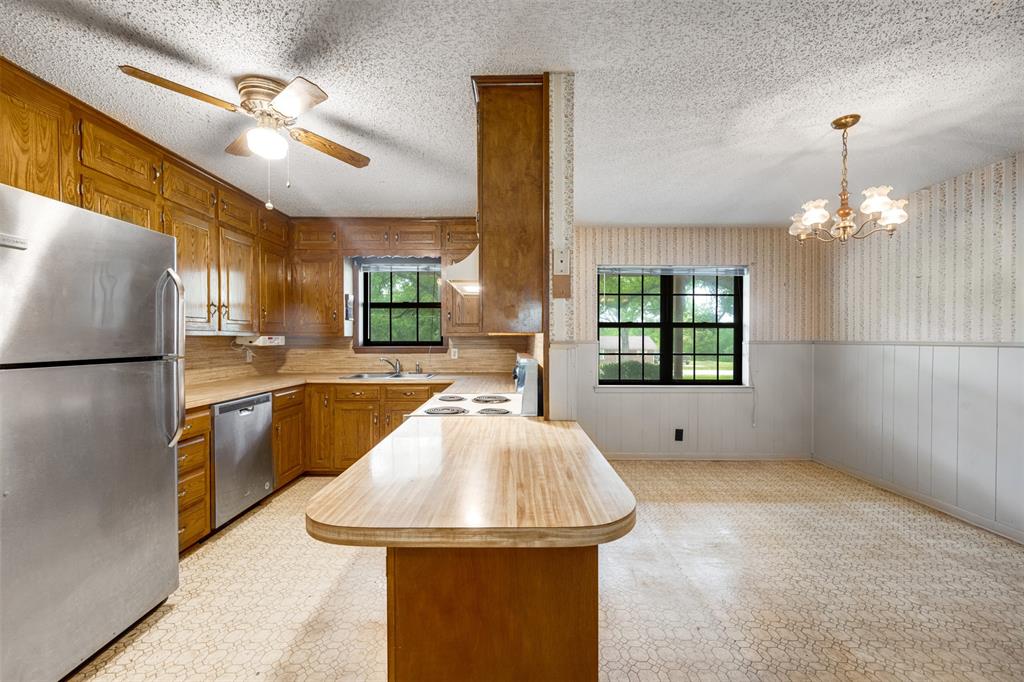8798 Hill N Dale Road Tyler, TX 75709 - Photo 13 of 31 Kitchen featuring ample wood cabinetry, stainless steel refrigerator and dishwasher, and a built-in electric stovetop