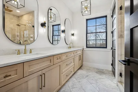 a spacious bathroom with a granite countertop sink mirror and vanity
