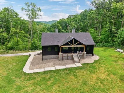 a view of a house with a yard porch and sitting area