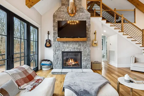 a living room with furniture a fireplace and a flat screen tv