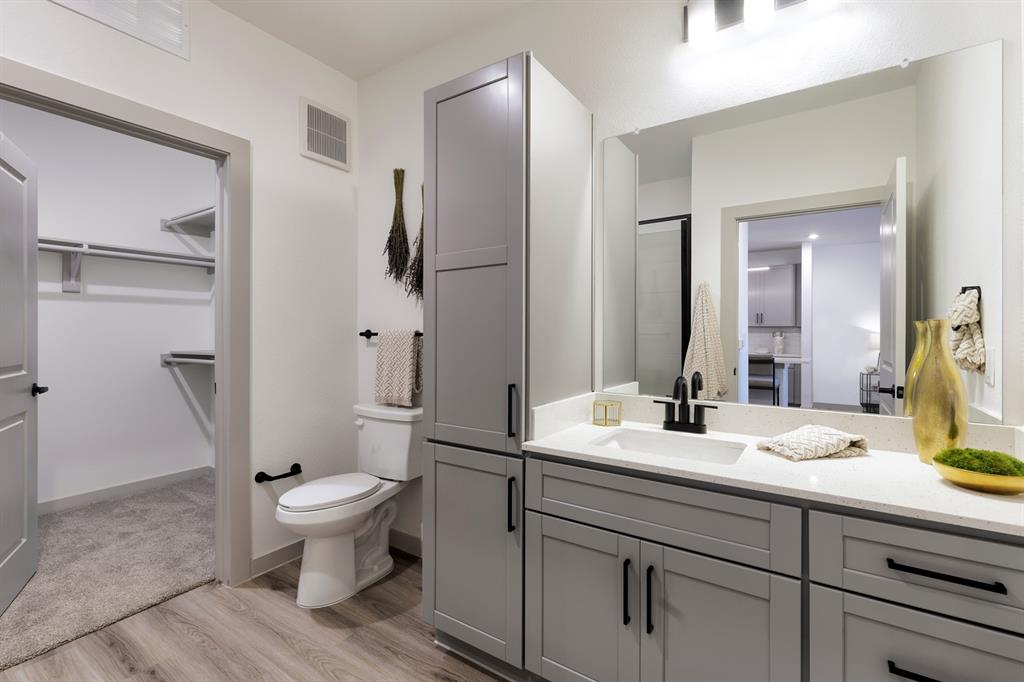 750 Turner Warnell Road, Unit 1205 Mansfield, TX 76063 - Photo 6 of 7 a bathroom with a sink toilet and shower
