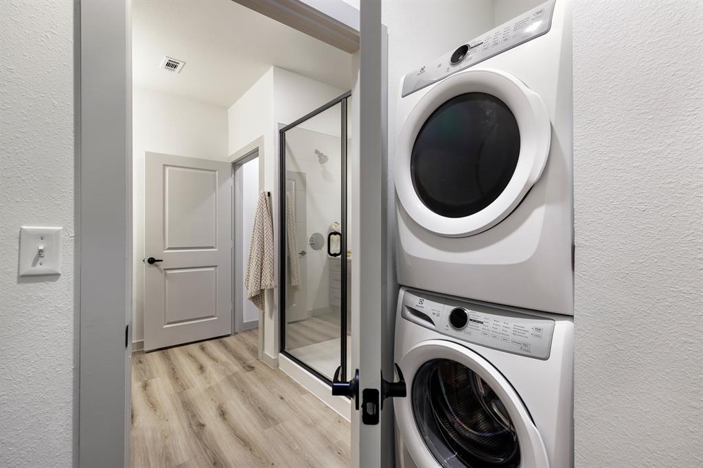 750 Turner Warnell Road, Unit 1205 Mansfield, TX 76063 - Photo 7 of 7 a view of a hallway with washer and dryer