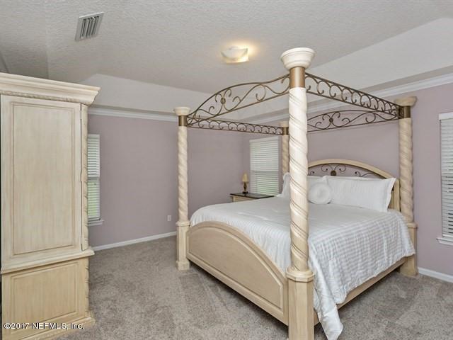 4445 Mandarin Ridge Court Jacksonville, FL 32258 - Photo 12 of 33 a bedroom with a bed and a window