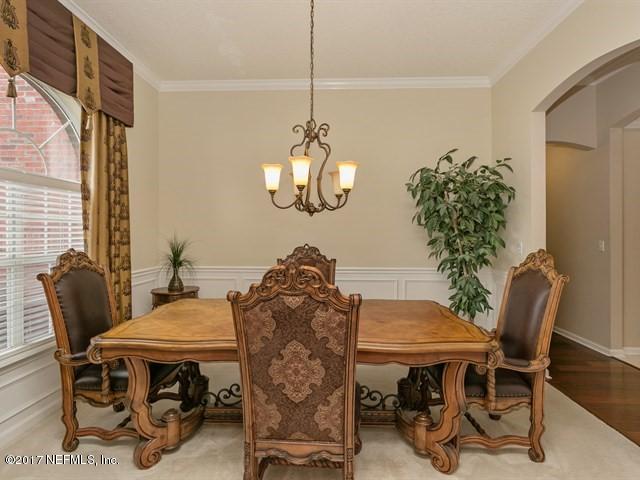 4445 Mandarin Ridge Court Jacksonville, FL 32258 - Photo 16 of 33 a view of a dining room with furniture and wooden floor