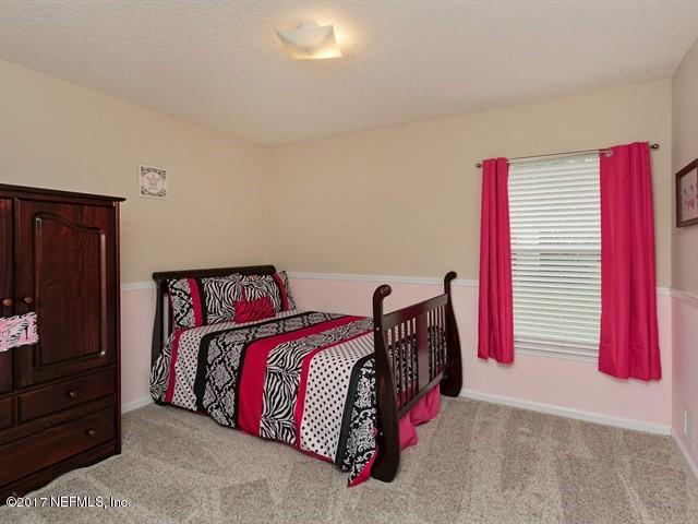 4445 Mandarin Ridge Court Jacksonville, FL 32258 - Photo 17 of 33 a bedroom with a bed and a closet