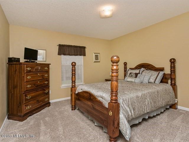 4445 Mandarin Ridge Court Jacksonville, FL 32258 - Photo 18 of 33 a bed room with a bed and a television