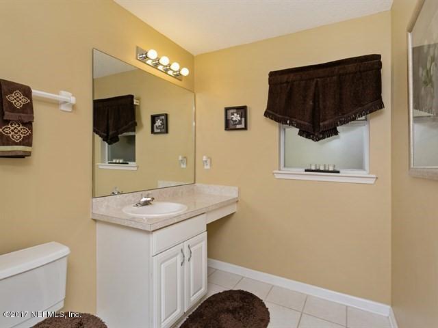 4445 Mandarin Ridge Court Jacksonville, FL 32258 - Photo 19 of 33 a bathroom with a sink a toilet and mirror