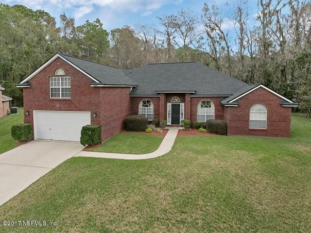 4445 Mandarin Ridge Court Jacksonville, FL 32258 - Photo 21 of 33 a front view of a house with a yard and garage