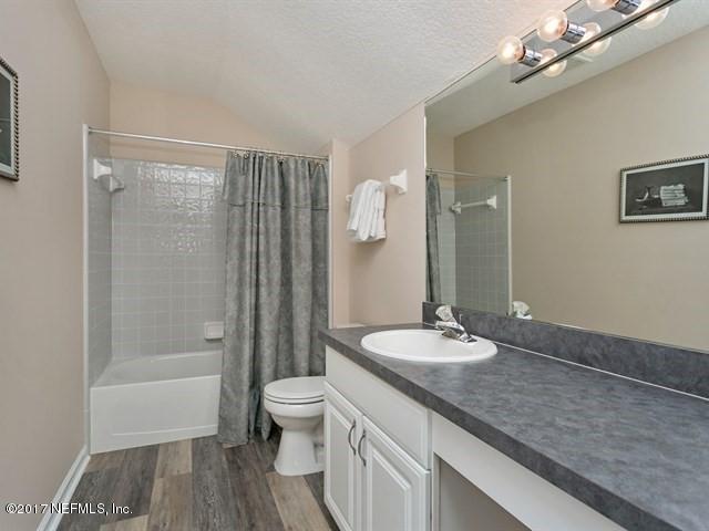 4445 Mandarin Ridge Court Jacksonville, FL 32258 - Photo 22 of 33 a bathroom with a granite countertop sink a toilet a mirror and shower