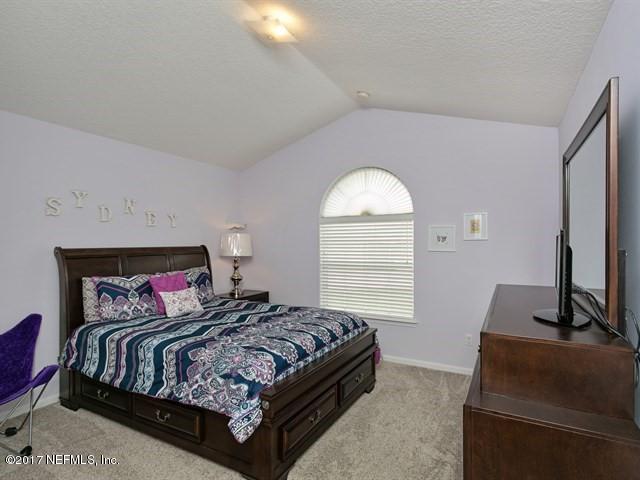 4445 Mandarin Ridge Court Jacksonville, FL 32258 - Photo 24 of 33 a bedroom with a bed and window