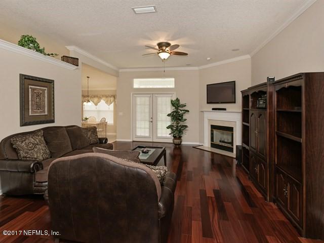 4445 Mandarin Ridge Court Jacksonville, FL 32258 - Photo 3 of 33 a living room with furniture a flat screen tv and wooden floor