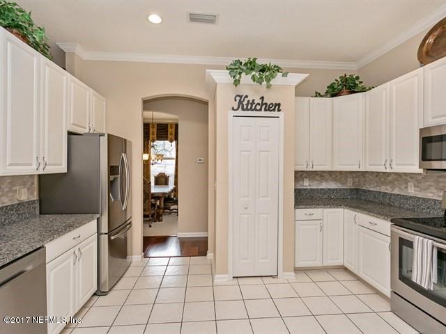 4445 Mandarin Ridge Court Jacksonville, FL 32258 - Photo 4 of 33 a kitchen with granite countertop a refrigerator and a sink