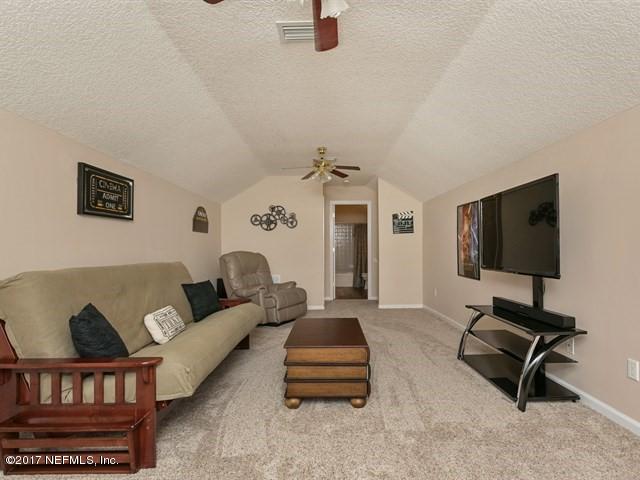 4445 Mandarin Ridge Court Jacksonville, FL 32258 - Photo 7 of 33 a living room with furniture and a flat screen tv