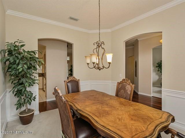 4445 Mandarin Ridge Court Jacksonville, FL 32258 - Photo 8 of 33 a bedroom with a bed and a potted plant