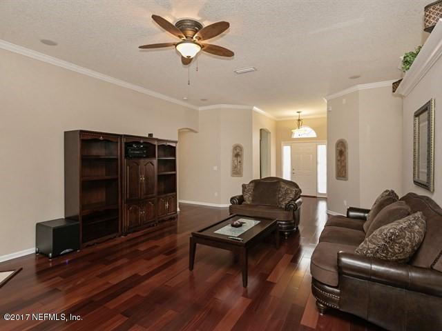 4445 Mandarin Ridge Court Jacksonville, FL 32258 - Photo 10 of 33 a living room with furniture and a flat screen tv