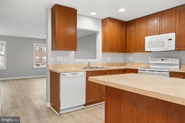 a kitchen with a sink a stove and cabinets
