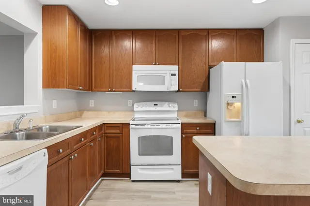 a kitchen with a cabinets and white appliances