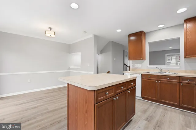 a kitchen with a sink a stove and cabinets