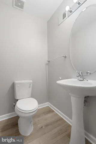 a bathroom with a sink toilet and a mirror