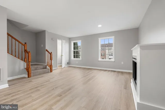 a view of a livingroom with wooden floor and a window