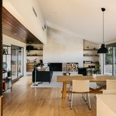 a living room with furniture a flat screen tv and a large window