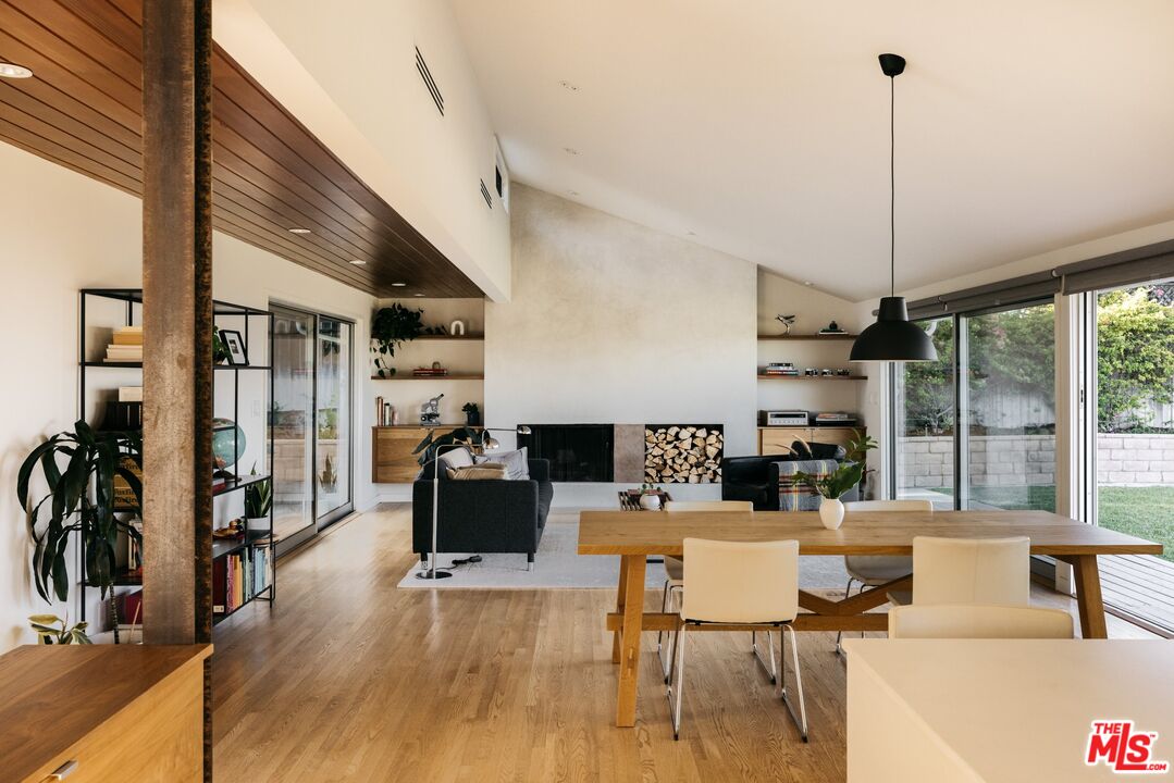 a living room with furniture a flat screen tv and a large window
