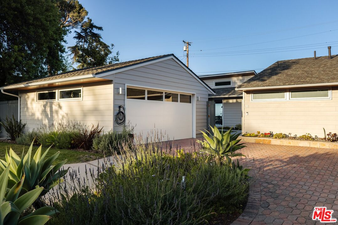 31 Silver Spring Drive Rolling Hills Estates, CA 90274 - Photo 2 of 46 a yellow house with flower garden in front of it