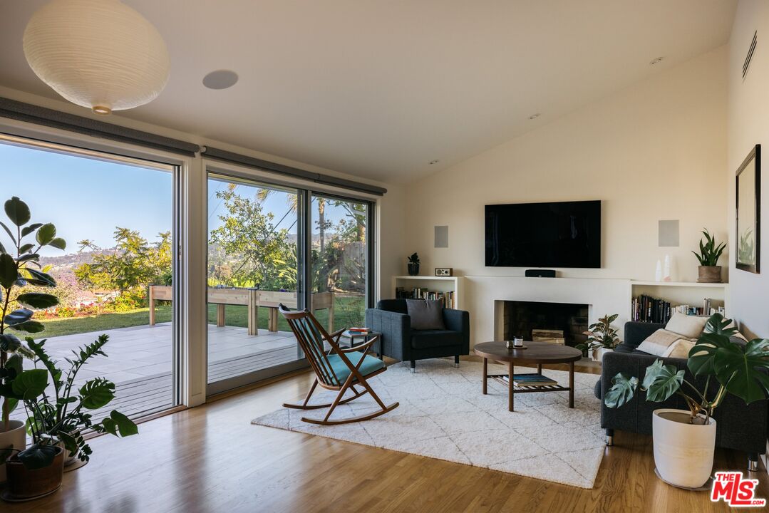 31 Silver Spring Drive Rolling Hills Estates, CA 90274 - Photo 27 of 46 a living room with furniture a fireplace and a flat screen tv