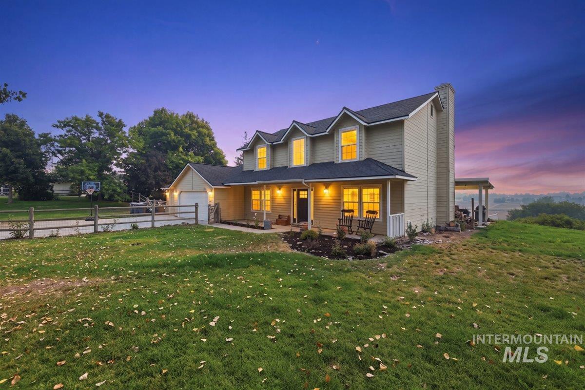 24440 Kenridge Road Caldwell, ID 83607 - Photo 2 of 48 Two-story residence featuring light siding and a dark roof
