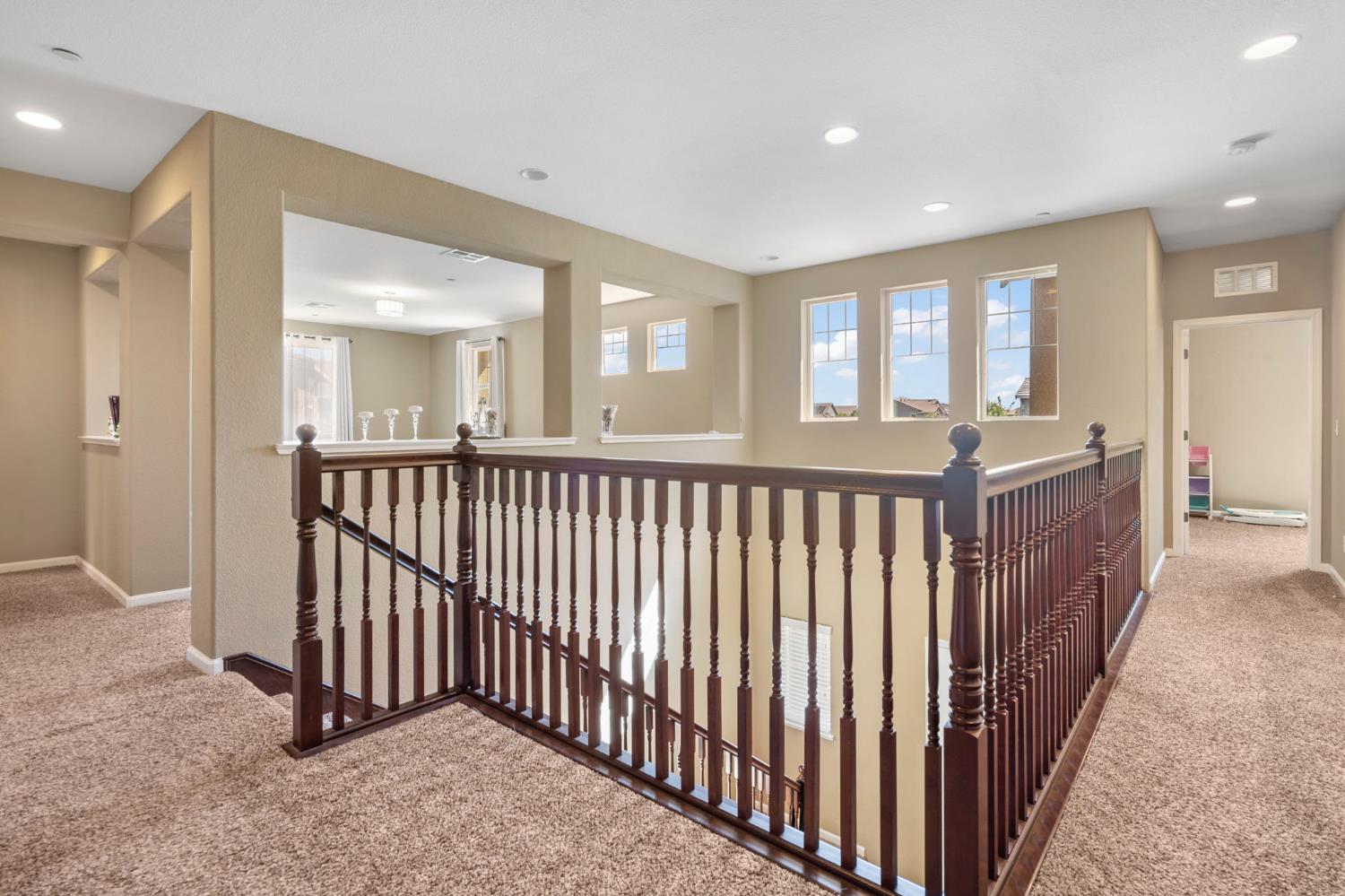 2317 Mathar Drive Manteca, CA 95337 - Photo 25 of 48 a view of a hallway with wooden floor and windows