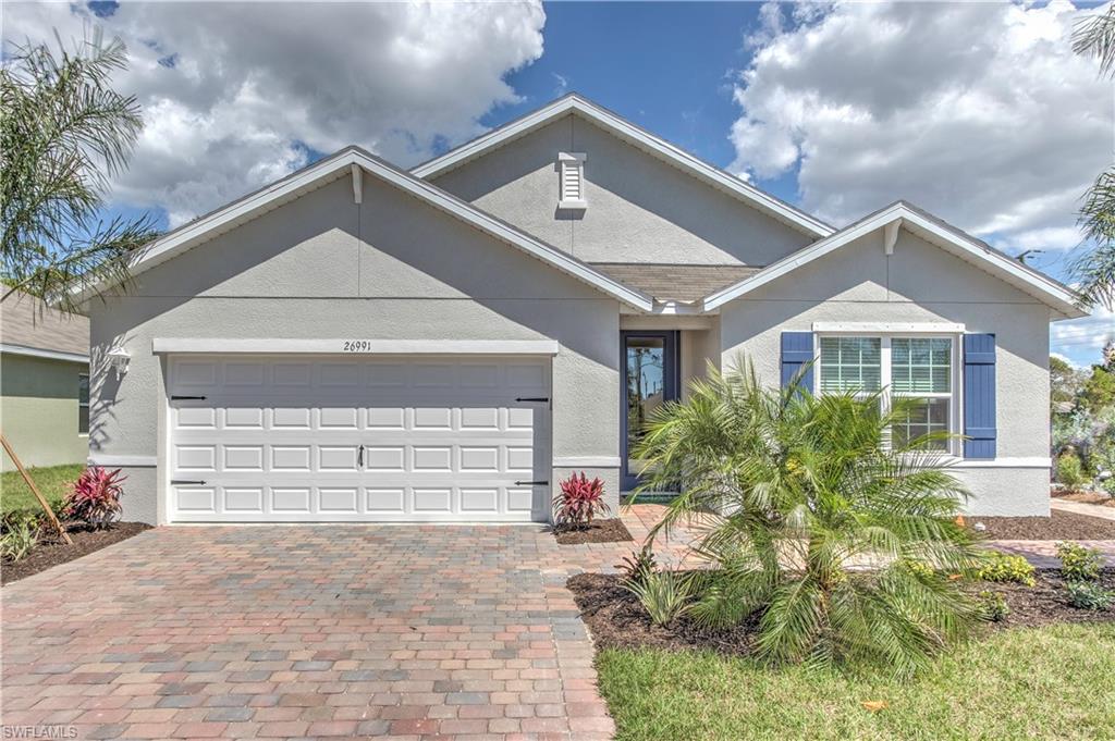 8137 Gopher Tortoise Trail Lehigh Acres, FL 33972 - Photo 1 of 21 a front view of a house with a yard and garage