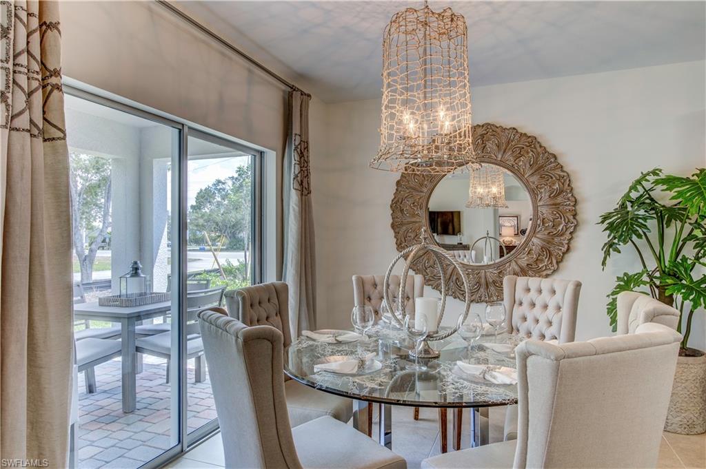 8137 Gopher Tortoise Trail Lehigh Acres, FL 33972 - Photo 8 of 21 a dining room with furniture a chandelier and wooden floor