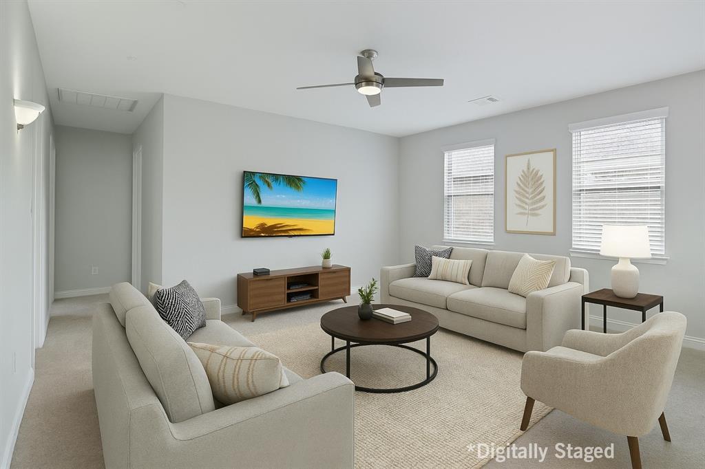 925 Spring Falls Drive McKinney, TX 75071 - Photo 22 of 40 a living room with furniture a large window and a table