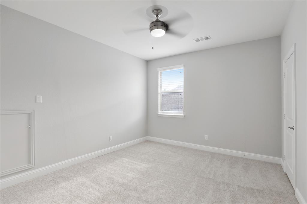 925 Spring Falls Drive McKinney, TX 75071 - Photo 24 of 40 wooden floor in an empty room with a window