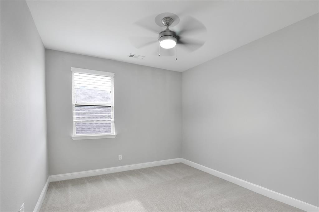 925 Spring Falls Drive McKinney, TX 75071 - Photo 25 of 40 an empty room with a window and a fan