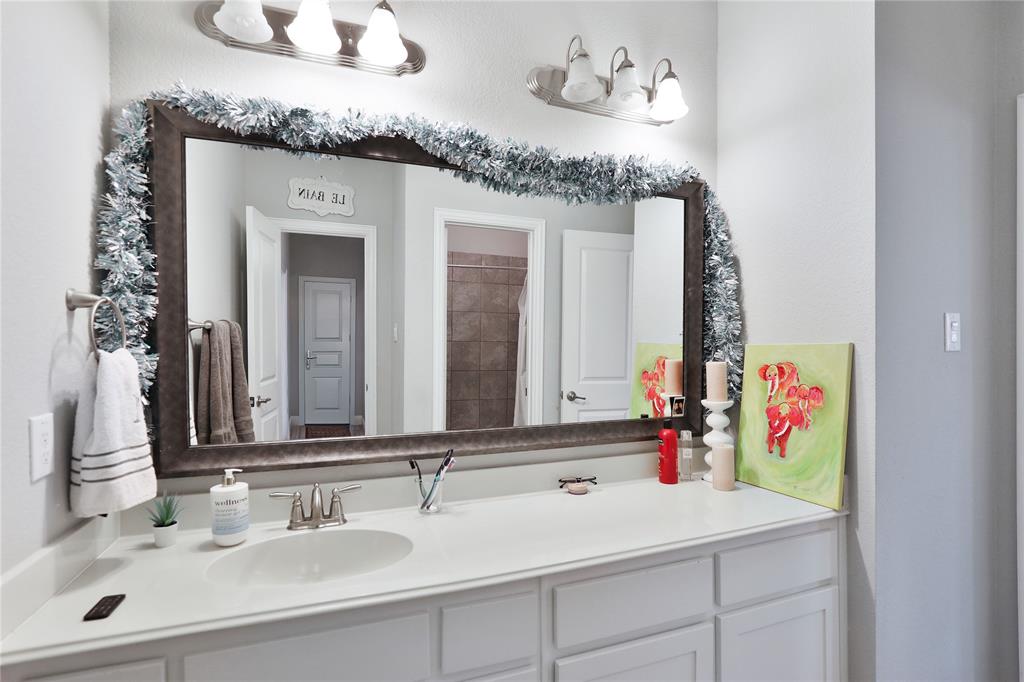 925 Spring Falls Drive McKinney, TX 75071 - Photo 26 of 40 a bathroom with a sink vanity and a mirror