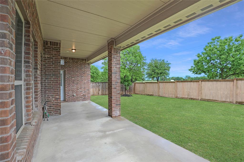 925 Spring Falls Drive McKinney, TX 75071 - Photo 28 of 40 a view of a backyard with wooden fence