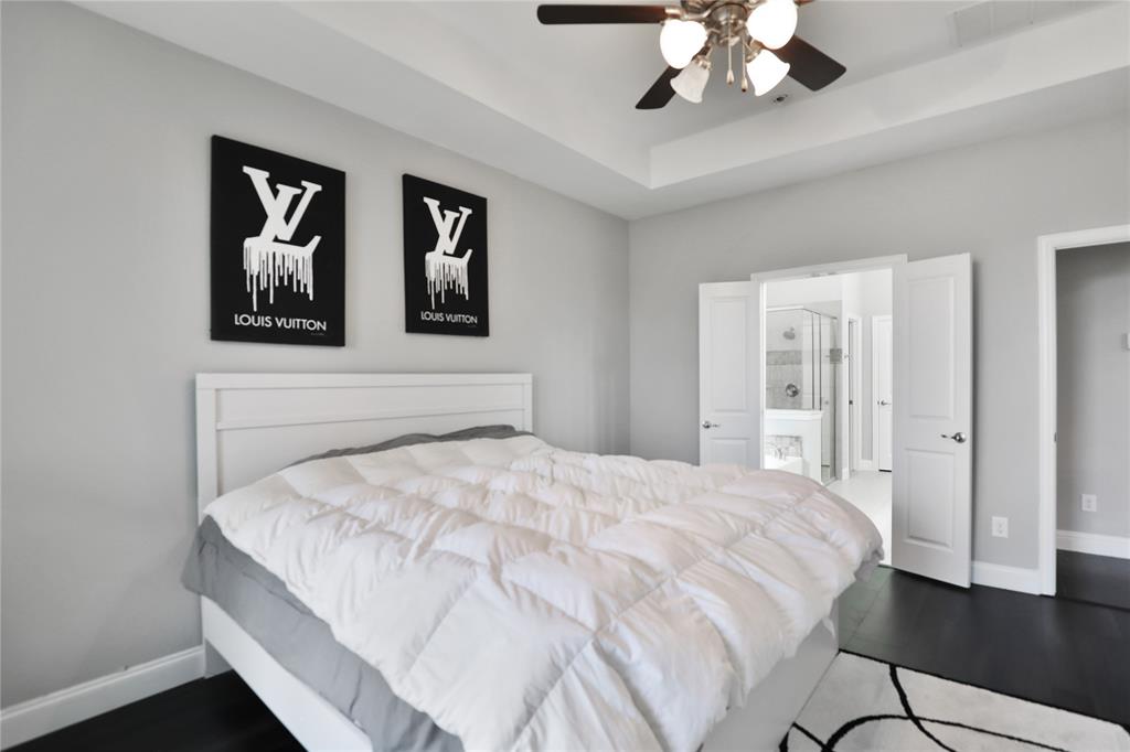 925 Spring Falls Drive McKinney, TX 75071 - Photo 4 of 40 a bedroom with a large bed and a chandelier