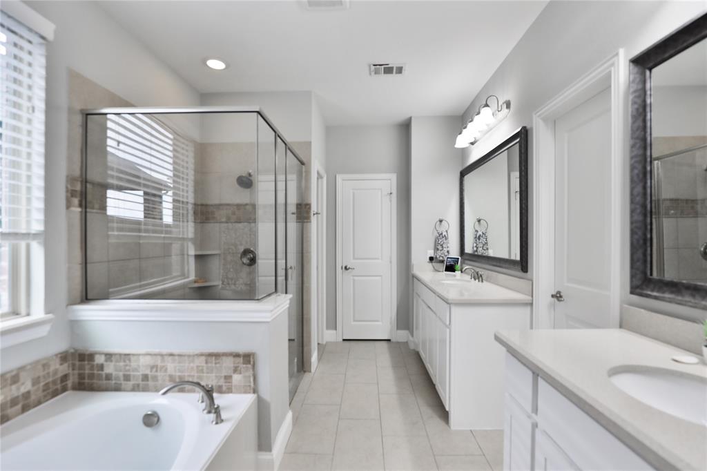 925 Spring Falls Drive McKinney, TX 75071 - Photo 5 of 40 a bathroom with a tub sink shower and mirror