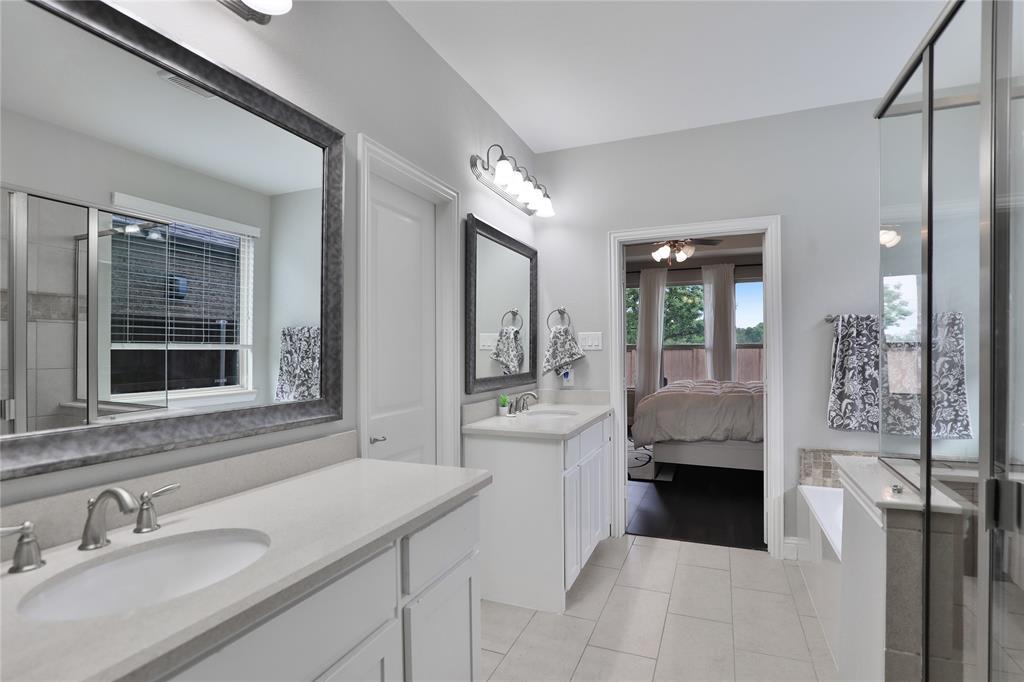 925 Spring Falls Drive McKinney, TX 75071 - Photo 6 of 40 a en suite bathroom with a granite countertop tub sink and mirror