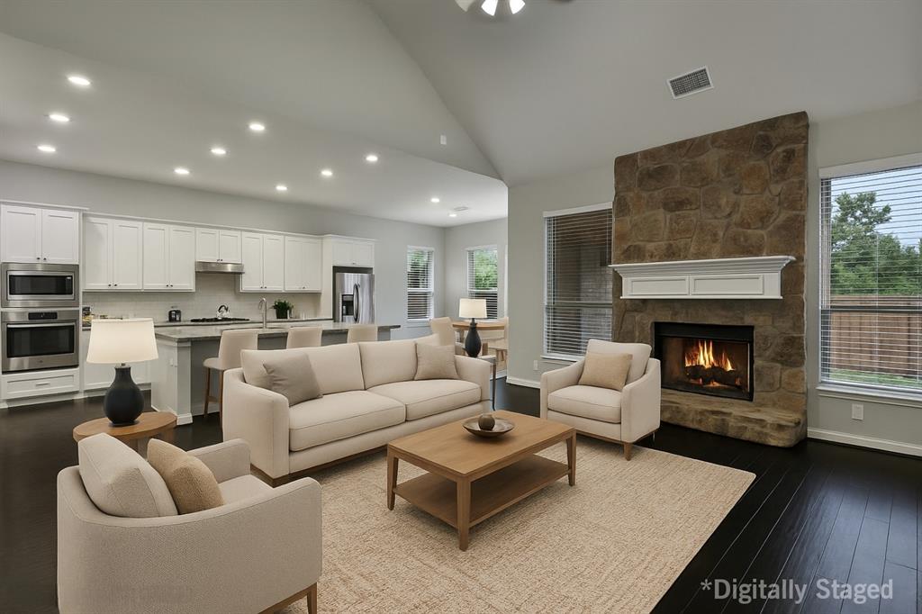 925 Spring Falls Drive McKinney, TX 75071 - Photo 7 of 40 a living room with furniture and a fireplace