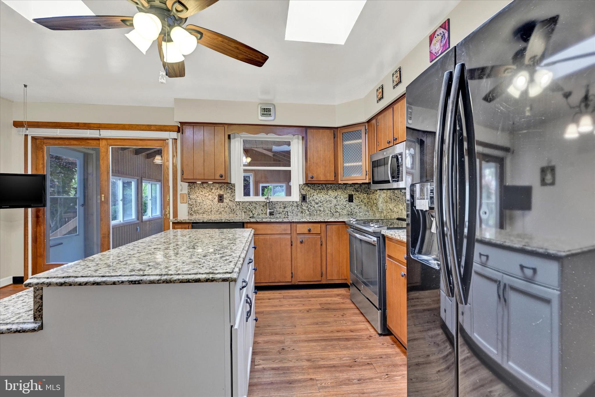 4009 Eland Road Phoenix, MD 21131 - Photo 12 of 38 a kitchen with stainless steel appliances granite countertop a sink and cabinets