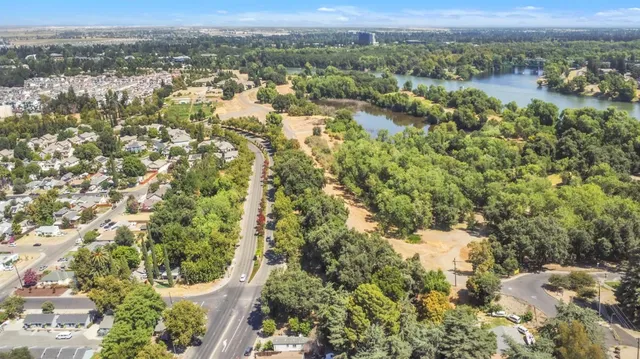 a view of a house with backyard and sitting area