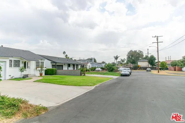 a view of a big room with a big yard and large trees