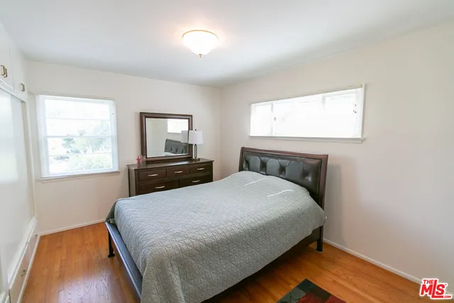 a bedroom with a bed and a night stand