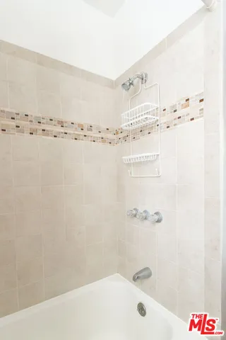a bathroom with a bathtub and shower