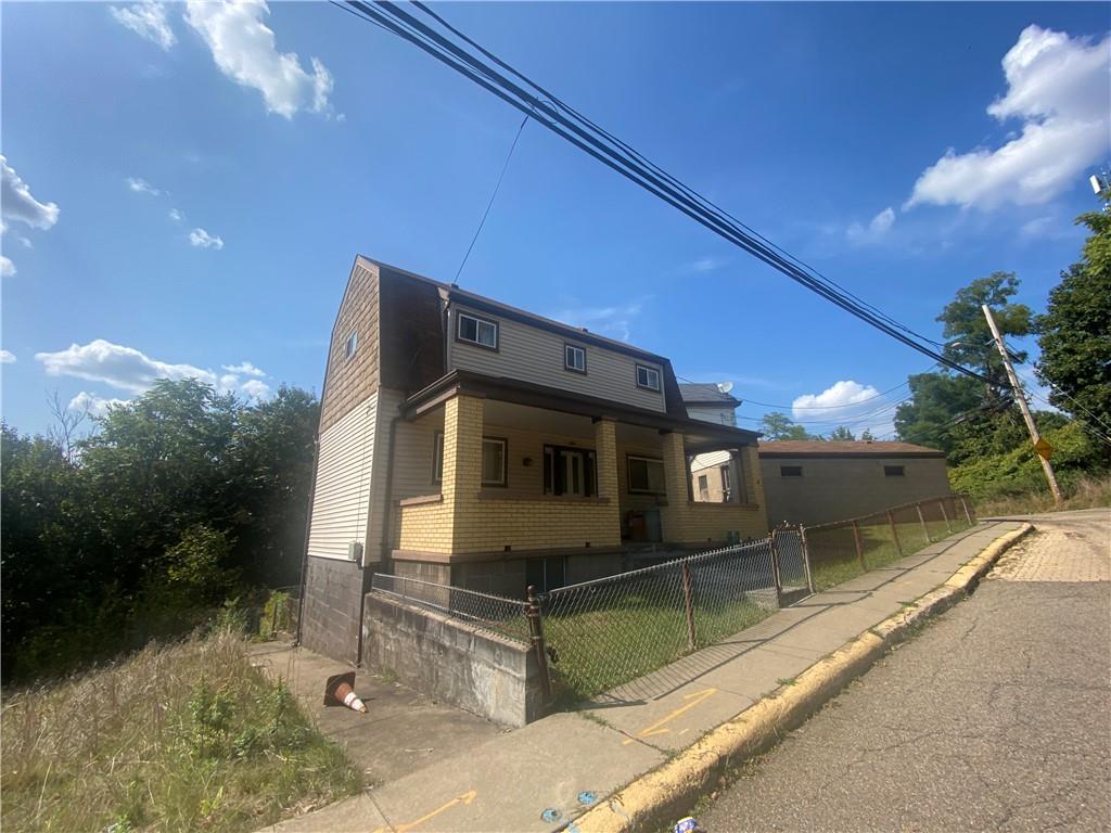 403 Bruce Street McKees Rocks, PA 15136 - Photo 1 of 20 a front view of a house with a yard