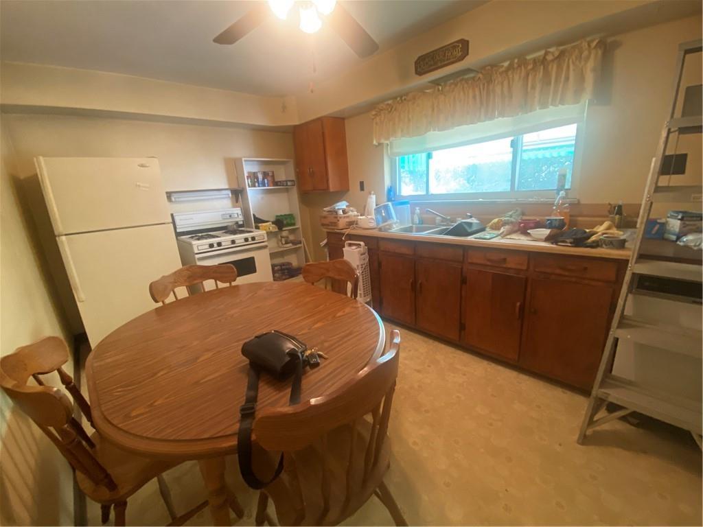 403 Bruce Street McKees Rocks, PA 15136 - Photo 6 of 20 a room with stainless steel appliances kitchen island granite countertop furniture a refrigerator and wooden floor