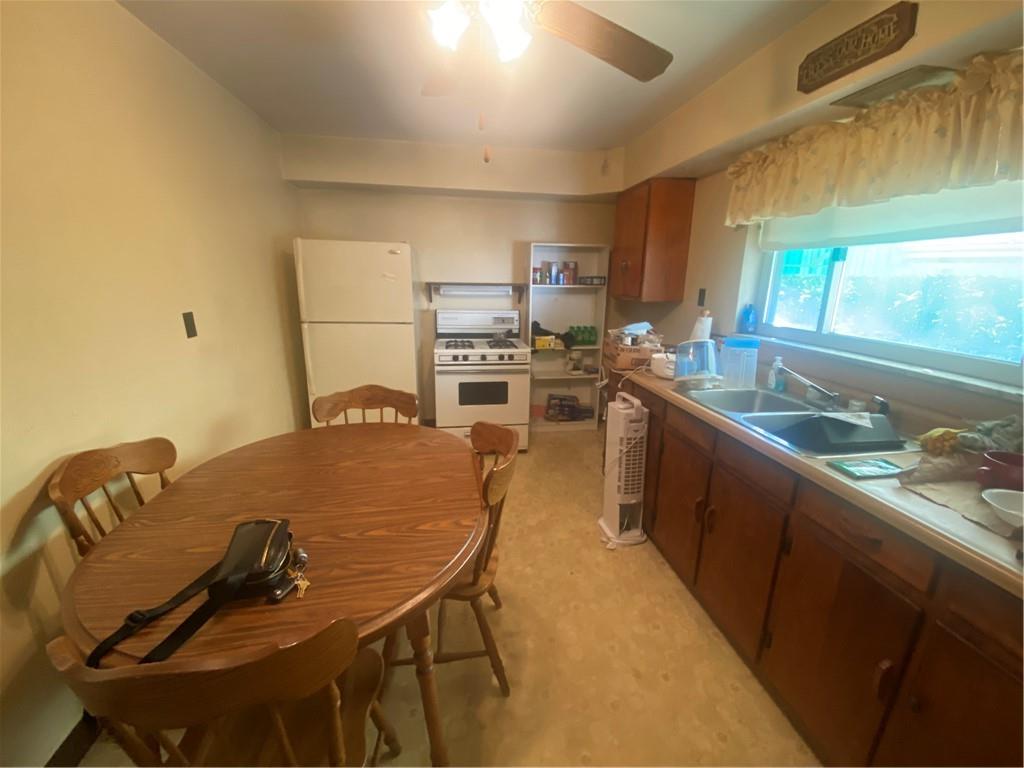 403 Bruce Street McKees Rocks, PA 15136 - Photo 7 of 20 a kitchen with a table chairs stove and cabinets