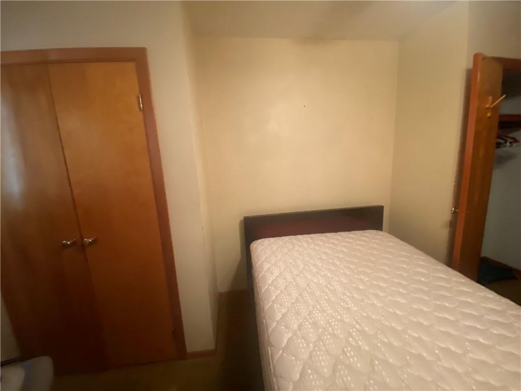 403 Bruce Street McKees Rocks, PA 15136 - Photo 10 of 20 a bed room with a bed and a mirror